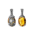 A handcrafted sterling silver pendant featuring a vivid Citrine Quartz framed in intricate Balinese filigree, showcasing traditional artistry and golden radiance.