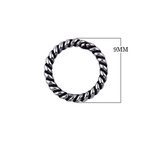 Handcrafted twisted closed jump ring in sterling silver with oxidized finish, artisan jewelry component from India.