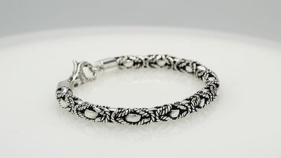 Wholesale sterling silver bracelet featuring a bold 5MM braided-pattern chain with oxidized detailing and a decorative lobster lock for secure fastening and strong craftsmanship.