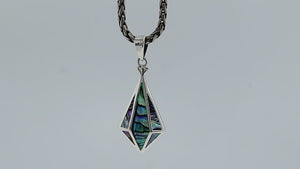 A handcrafted sterling silver pendant featuring a luminous Abalone Shell in a geometric triangular pattern, showcasing a fusion of modern and Balinese artistry.
