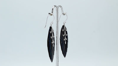Sterling silver black shell carved leaf drop earrings with polished silver vine detailing and handcrafted dark shell finish.