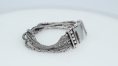 Sterling silver multi-chain panel bracelet with polished finish and handcrafted silver detailing.