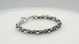 Wholesale sterling silver bracelet featuring a 6MM braided rope-pattern chain with oxidized highlights and an ornate lobster lock designed for strong, secure, handcrafted Balinese quality.