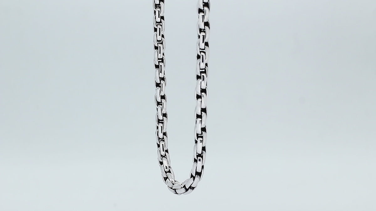 Sterling silver round box link chain necklace featuring substantial interlocking links, polished surfaces, oxidized recessed details, and a streamlined decorative push clasp.