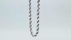 Sterling silver round box link chain necklace featuring substantial interlocking links, polished surfaces, oxidized recessed details, and a streamlined decorative push clasp.