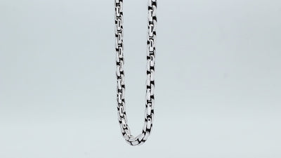Sterling silver round box link chain necklace featuring substantial interlocking links, polished surfaces, oxidized recessed details, and a streamlined decorative push clasp.