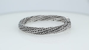 Sterling silver multi-strand braided chain bracelet featuring intricate woven textures, oxidized detailing, polished accents, and an engraved rectangular push clasp.