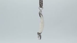 Sterling silver half-moon pendant with carved bone face and amethyst gemstone, Balinese design.