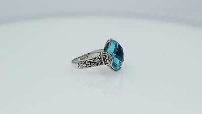 Sterling silver ring with faceted round Blue Topaz Quartz and Balinese scrollwork handcrafted in Bali.
