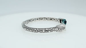 Sterling Silver Dragon Head Bangle with Blue Topaz Quartz handcrafted in Bali featuring intricate filigree and oxidized detailing.