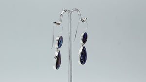 Sterling silver Abalone Shell dangle earrings featuring round upper settings and teardrop lower drops with vivid blue, green, violet, and turquoise iridescent patterns.