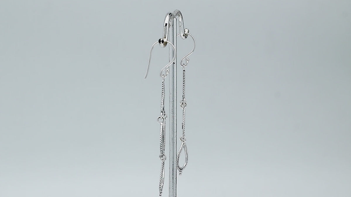 Sterling silver chandelier drop earrings featuring four open teardrop frames, twisted rope borders, small bead accents, articulated tiered construction, and elongated ear wires.