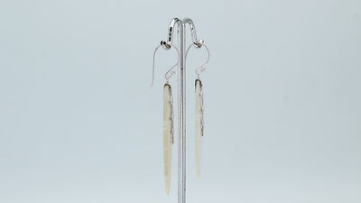 Sterling silver mother of pearl carved leaf drop earrings with polished silver detailing and handcrafted shell design.