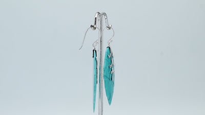 Sterling silver turquoise shell carved leaf drop earrings with polished silver detailing and handcrafted stone design.