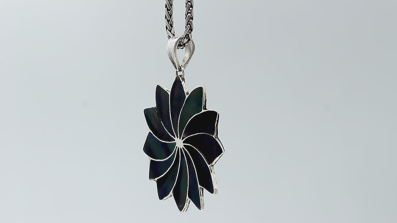 Sterling silver flower pendant with genuine black shell, handcrafted in Bali with petal design – wholesale gemstone jewelry supplier.