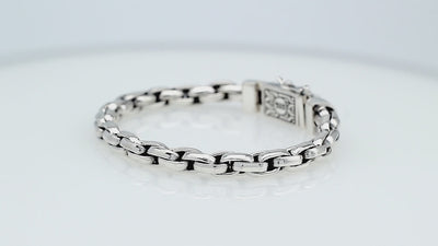 Sterling silver round braided link chain bracelet featuring substantial interwoven links, polished surfaces, oxidized accents, and an engraved decorative box clasp.