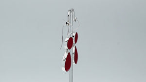 Sterling silver Red Coral dangle earrings featuring a round upper element and teardrop lower drop, polished bezel settings, articulated construction, and elongated ear wires.