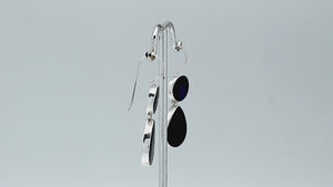 Sterling silver Black Shell dangle earrings featuring glossy round and teardrop elements, polished bezel settings, articulated double-drop construction, and elongated silver ear wires.