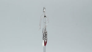 Sterling silver oval drop earrings featuring rich Red Coral inlay, open center design, sculpted scroll motifs, oxidized detailing, polished borders, and French ear wires.