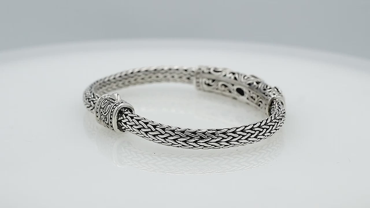 Sterling silver woven bracelet with blue and purple quartz gemstones, handcrafted in Bali.