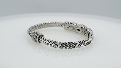 Sterling silver woven bracelet with blue and purple quartz gemstones, handcrafted in Bali.