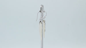 Sterling silver mother of pearl carved leaf drop earrings with polished silver bead detailing and handcrafted shell design.