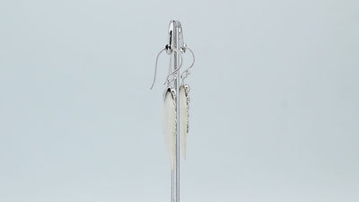 Sterling silver mother of pearl carved leaf drop earrings with polished silver bead detailing and handcrafted shell design.