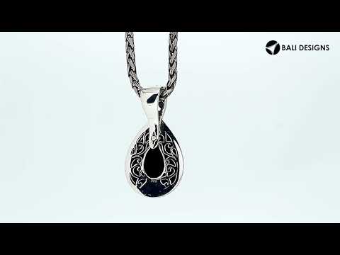 Sterling silver teardrop pendant featuring faceted Black Onyx set in a carved Balinese frame with a polished high-gloss shine.