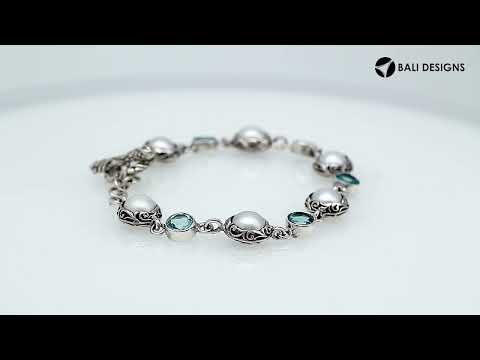 Wholesale sterling silver bracelet featuring alternating Mabe pearl and Blue Topaz quartz round links with oxidized detailing and a secure toggle lock design.