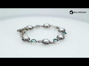 Wholesale sterling silver bracelet featuring alternating Mabe pearl and Blue Topaz quartz round links with oxidized detailing and a secure toggle lock design.