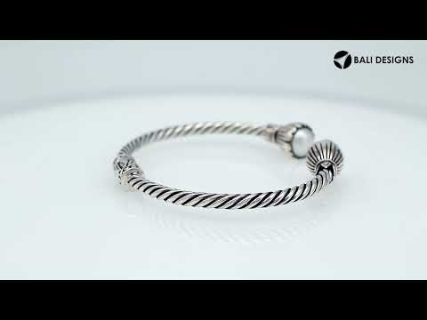 Wholesale sterling silver twisted cable cuff bracelet featuring smooth Mabe pearl end caps, hinge lock, and artisan detailing for premium jewelry assortments.