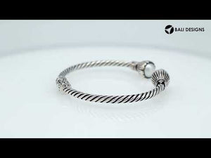 Wholesale sterling silver twisted cable cuff bracelet featuring smooth Mabe pearl end caps, hinge lock, and artisan detailing for premium jewelry assortments.
