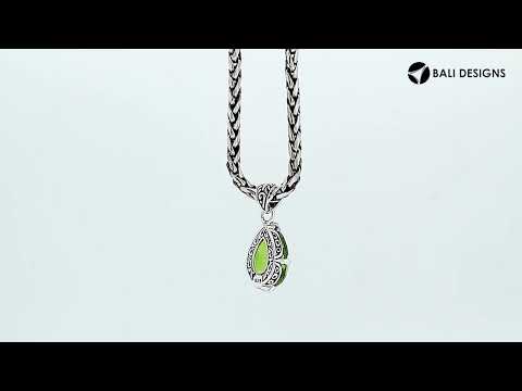 Sterling silver pear-shaped pendant featuring a faceted Peridot Quartz centerpiece with polished prong-setting and detailed Balinese carved ornamental accents.