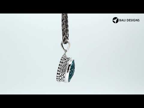 Sterling silver oval pendant with faceted Blue Topaz Quartz and ornate detailing, handcrafted in Bali