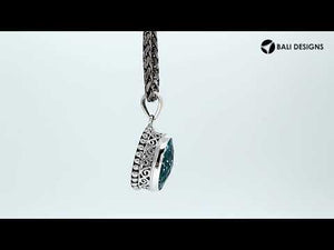 Sterling silver oval pendant with faceted Blue Topaz Quartz and ornate detailing, handcrafted in Bali