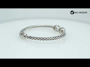 Wholesale sterling silver Pearl bangle with twisted rope design, oxidized finish, and Balinese motifs, handcrafted in Bali.