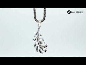 A handcrafted sterling silver feather pendant featuring a flowing leaf design with a mirror-polished finish and smooth texture.