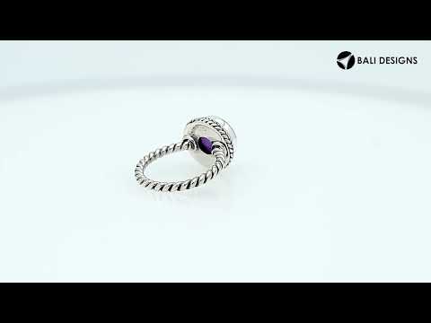 Sterling silver ring with a round Amethyst Quartz and rope-style band design.