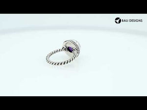 Sterling silver ring with a round Amethyst Quartz and rope-style band design.