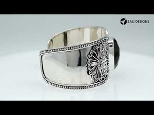 Wholesale sterling silver Bali engraved wide cuff bracelet featuring a bold labradorite centerpiece, enhanced with polished–oxidized detailing for premium bulk jewelry selection.