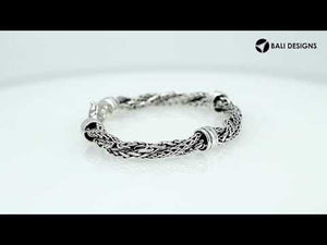 Sterling Silver bracelet featuring a twisted woven chain design with polished metal connectors and a secure lobster clasp, crafted for durable and elegant wholesale presentation.
