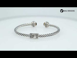 Sterling silver wholesale bangle with twisted rope design, accented by Citrine Quartz and Cubic Zirconia with Balinese motifs.