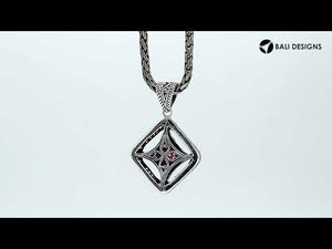 A handcrafted sterling silver pendant featuring a radiant Red Garnet Quartz in a Balinese filigree square frame with detailed silverwork.