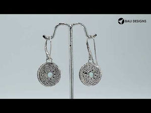 Wholesale sterling silver round earrings with Blue Topaz Quartz and patterned frame.