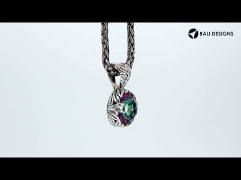 A sterling silver round pendant designed with a vibrant Mystic Quartz center, surrounded by detailed Balinese leaf carvings and a smoothly polished artistic frame.
