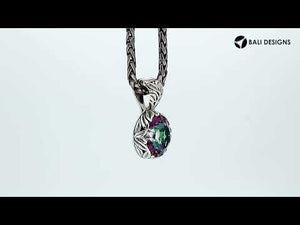 A sterling silver round pendant designed with a vibrant Mystic Quartz center, surrounded by detailed Balinese leaf carvings and a smoothly polished artistic frame.