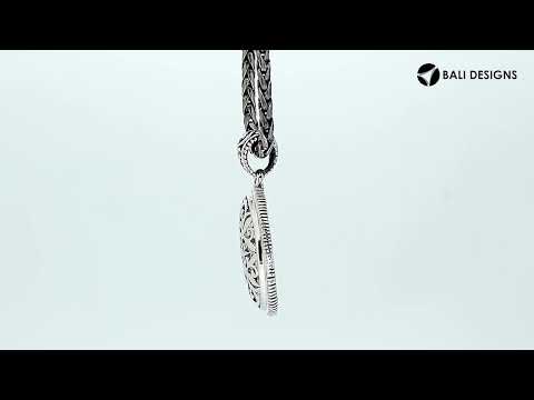 Wholesale sterling silver oval pendant with ornate floral carved design.