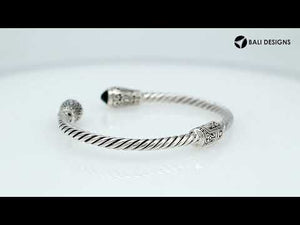 Sterling silver twisted bangle with green quartz ends and Balinese carvings, handcrafted in Bali