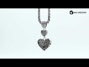 Sterling silver double heart pendant with Black Shell and Balinese detailing in polished finish.
