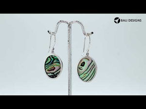 Wholesale sterling silver earrings featuring bright turquoise shell ovals with a polished wave-motif overlay, offering consistent artisan craftsmanship and elegant catalog-ready appeal for bulk jewelry sourcing.